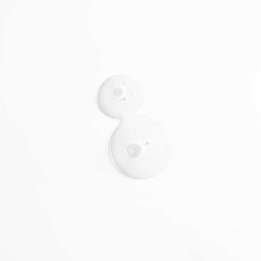 Texture of Double Hyaluronic Serum, two clear drops on a white background