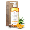 Moisture Defense Vitamin C Body Wash pump bottle in front of its kraft box, around it are soapberry, aloe vera and orange slices against a white background