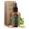  Ginseng Green Tea Toner Spray amber bottle in front of its kraft box, with rose petals, green tea leaves and ginseng root slices around it